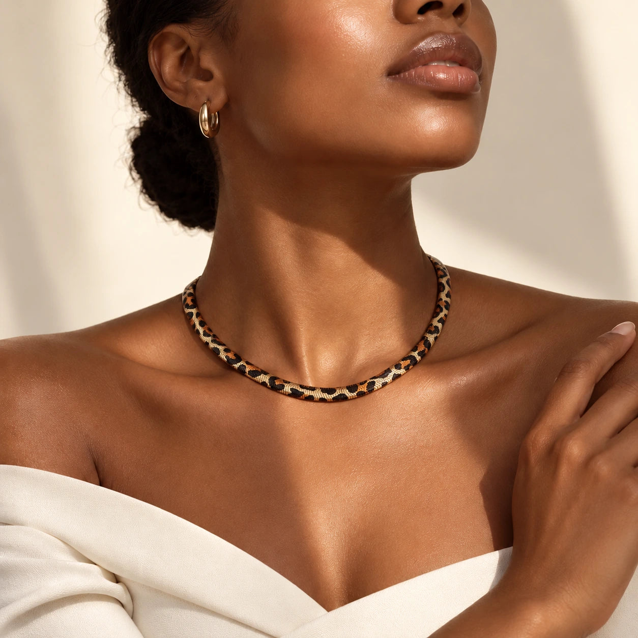 Close-up of a model styling the snake necklace
