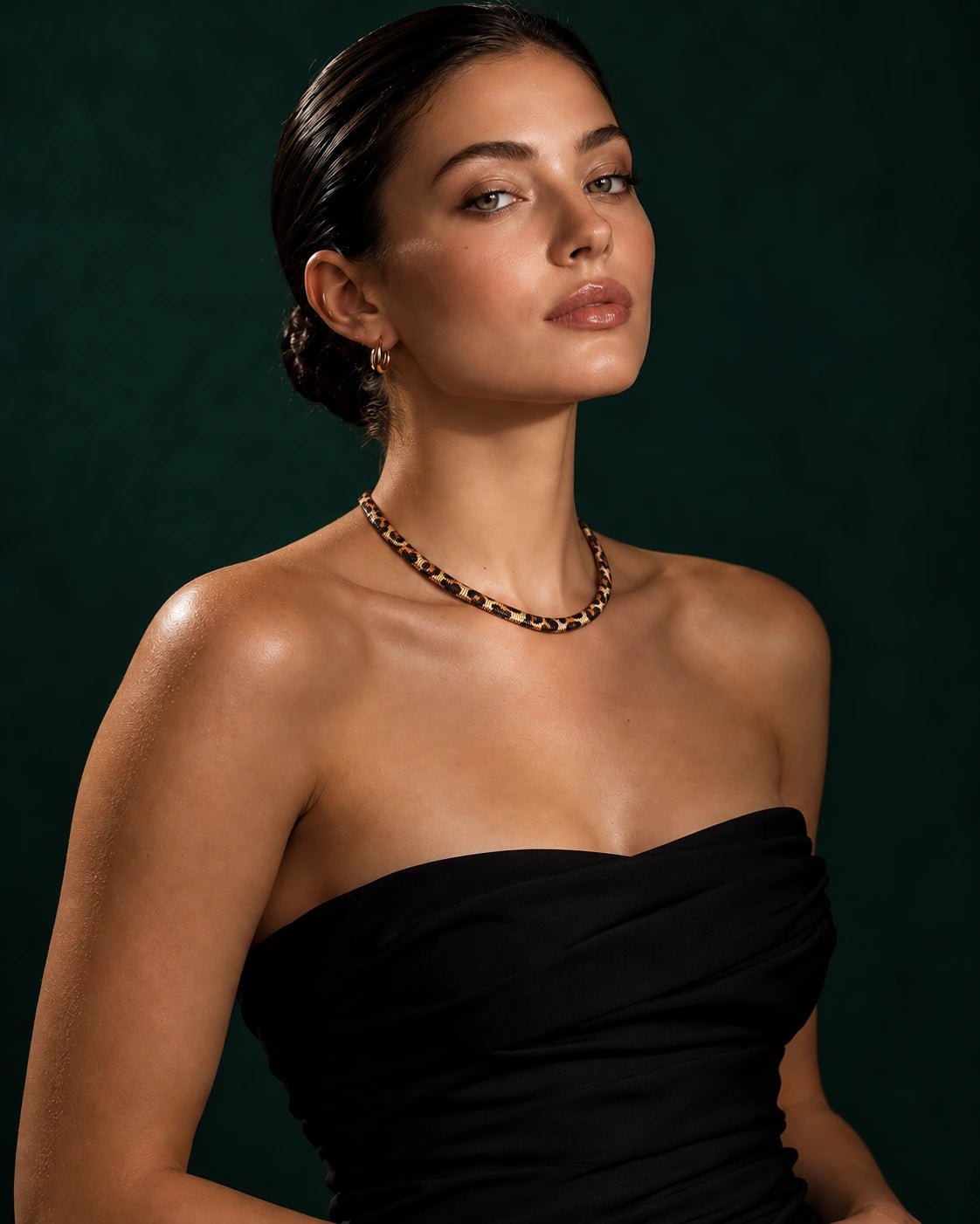 Woman wearing the gold-tone leopard-print snake necklacef